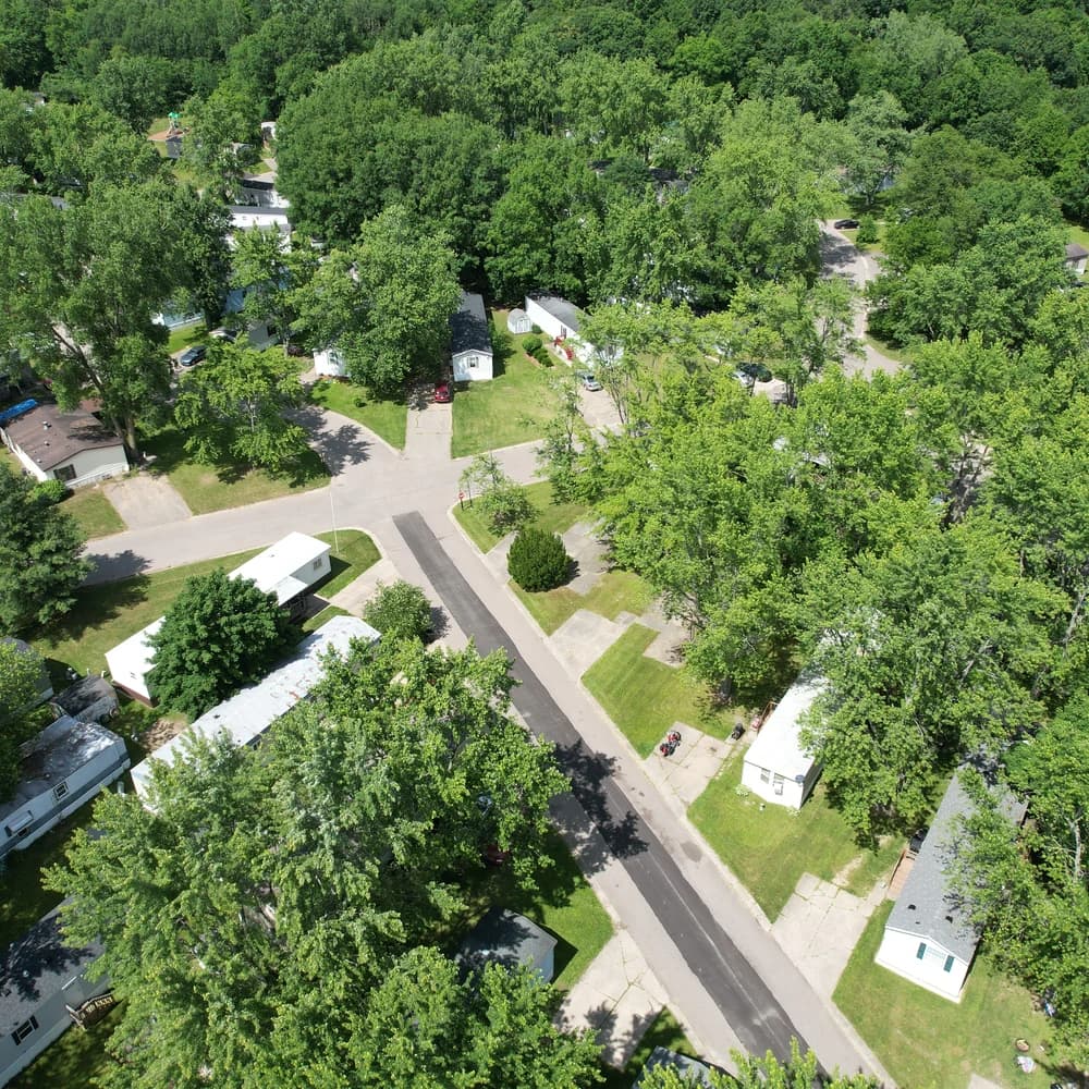 Homes and lawns beneath mature trees at Davison Hills